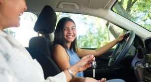 Smiling student accepting car keyes